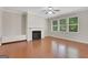 Inviting living room featuring hardwood floors, a cozy fireplace, and bright windows at 1300 Hopkins Dr, Decatur, GA 30033