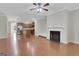 Open concept living room with hardwood floors, a fireplace, and a view into the kitchen at 1300 Hopkins Dr, Decatur, GA 30033