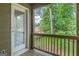 An outdoor patio features a view of mature trees, partial home view, and a glass door with blinds at 1300 Hopkins Dr, Decatur, GA 30033