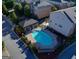 Aerial view of a sparkling community pool with a pergola, surrounded by well-maintained landscaping and townhomes at 1300 Hopkins Dr, Decatur, GA 30033