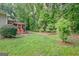 Large backyard with a lush lawn and mature trees, adjacent to screened porch at 835 Virginia Parks, Fayetteville, GA 30215