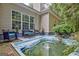 Backyard patio area has outdoor seating and a quaint pond with stone accents for relaxing and enjoying the outdoors at 835 Virginia Parks, Fayetteville, GA 30215