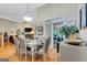 Open-concept dining area with elegant table set, leading to a sunroom and living space at 835 Virginia Parks, Fayetteville, GA 30215