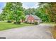 Brick home featuring a long driveway and well-maintained lawn at 835 Virginia Parks, Fayetteville, GA 30215