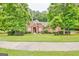 Charming brick home with lush green lawn and mature trees at 835 Virginia Parks, Fayetteville, GA 30215