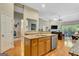 Open-concept kitchen with island bar, granite countertops, and view to the living room at 835 Virginia Parks, Fayetteville, GA 30215