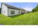 Spacious backyard with lush green lawn, partial view of house exterior, and room for outdoor activities at 1535 Fenmore St, Lithia Springs, GA 30122