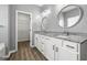 Bright bathroom featuring double vanity, granite countertop, white cabinets, and a walk-in closet at 1535 Fenmore St, Lithia Springs, GA 30122