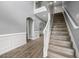 Elegant foyer with staircase, light gray walls, crisp white trim and wood-look laminate flooring throughout at 1535 Fenmore St, Lithia Springs, GA 30122