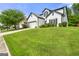 Traditional home offers manicured lawn, a two-car garage, and a side perspective of the well-kept yard at 1535 Fenmore St, Lithia Springs, GA 30122