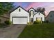 Charming home features a manicured lawn, two-car garage, and classic white siding with black trim details at 1535 Fenmore St, Lithia Springs, GA 30122
