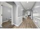 Hallway with hardwood flooring and decorative trim, leading to rooms with arched doorways at 1535 Fenmore St, Lithia Springs, GA 30122
