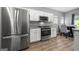 Kitchen with stainless steel appliances, modern finishes, and adjacent dining area at 1535 Fenmore St, Lithia Springs, GA 30122