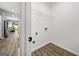 Bright laundry room with laminate wood flooring, utility connections, and a wire shelf for storage at 1535 Fenmore St, Lithia Springs, GA 30122