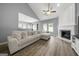 Spacious living room with fireplace, vaulted ceiling, ceiling fan, and views to kitchen and dining at 1535 Fenmore St, Lithia Springs, GA 30122