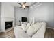 Bright living room features a fireplace, ceiling fan, and plush corduroy sofa at 1535 Fenmore St, Lithia Springs, GA 30122