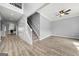 Spacious open-concept living room with hardwood floors and staircase featuring white railings at 1535 Fenmore St, Lithia Springs, GA 30122