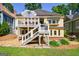 Rear exterior showcasing a deck, yellow siding, well-maintained landscaping, and a grill at 381 Cherokee Se Ave, Atlanta, GA 30312