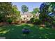 Expansive backyard featuring a fire pit, mature trees, and lush green grass at 381 Cherokee Se Ave, Atlanta, GA 30312