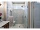 A modern bathroom shower enclosed in glass featuring white tile and a window at 381 Cherokee Se Ave, Atlanta, GA 30312