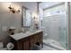 Bathroom featuring an antique vanity, marble countertop, and modern glass-enclosed shower with white tile at 381 Cherokee Se Ave, Atlanta, GA 30312