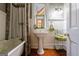 Bathroom with a clawfoot tub, pedestal sink, and beadboard walls at 381 Cherokee Se Ave, Atlanta, GA 30312