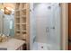 Modern glass-enclosed shower with white tile, built-in shelves, and marble countertop vanity at 381 Cherokee Se Ave, Atlanta, GA 30312