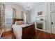Bedroom showcasing a decorative fireplace and wooden furnishings with floral curtains at 381 Cherokee Se Ave, Atlanta, GA 30312