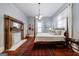 Bedroom featuring a vintage fireplace with decorative tile, hardwood floors and four-poster bed at 381 Cherokee Se Ave, Atlanta, GA 30312