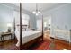Bedroom featuring hardwood floors, four-poster bed and vintage furnishing at 381 Cherokee Se Ave, Atlanta, GA 30312