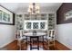 Bright breakfast nook with white shelving, chandelier, and a large window at 381 Cherokee Se Ave, Atlanta, GA 30312