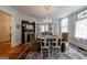 Bright dining room with a decorative fireplace, chandelier, hardwood floors, and vintage-style furniture at 381 Cherokee Se Ave, Atlanta, GA 30312