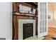 Ornate carved wood fireplace with decorative tiles and a mirrored mantel, adding vintage charm to the room at 381 Cherokee Se Ave, Atlanta, GA 30312