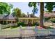 Quaint yellow home with a white picket fence and a well-manicured front yard at 381 Cherokee Se Ave, Atlanta, GA 30312