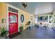 Inviting front porch with a red door, vintage furniture, and a view of a neighboring home at 381 Cherokee Se Ave, Atlanta, GA 30312