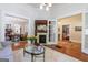 Cozy living room with hardwood floors, fireplace, open doorways to other rooms, and lots of natural light at 381 Cherokee Se Ave, Atlanta, GA 30312