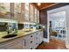 Elegant wet bar featuring custom cabinetry, granite countertops, and a mirrored backsplash for added ambiance at 381 Cherokee Se Ave, Atlanta, GA 30312