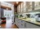 Stylish wet bar area with custom cabinets, granite countertops, and mirrored backsplash for easy entertaining at 381 Cherokee Se Ave, Atlanta, GA 30312