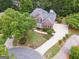 Aerial view of brick home on a cul-de-sac with beautifully landscaped front yard at 151 Overhill Point, Alpharetta, GA 30005