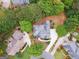 Aerial view of the house featuring a well-manicured yard, patio area, and mature trees at 151 Overhill Point, Alpharetta, GA 30005
