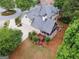 An aerial view of a home with an outdoor deck, screened in porch, fire pit and lush landscaping around the home at 151 Overhill Point, Alpharetta, GA 30005