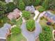 Aerial view of the home showcasing its beautiful landscaping, circular driveway, and mature trees in a cul-de-sac at 151 Overhill Point, Alpharetta, GA 30005