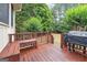 An outdoor wood deck with a bench and grill at 151 Overhill Point, Alpharetta, GA 30005
