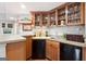 The basement bar includes wooden cabinetry, a sink, and a mini fridge at 151 Overhill Point, Alpharetta, GA 30005