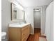 Bathroom with wood cabinets, a large mirror, and wood-look floors at 151 Overhill Point, Alpharetta, GA 30005