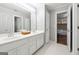 Bathroom features a double vanity, modern fixtures, white cabinets, and white hexagonal tile flooring at 151 Overhill Point, Alpharetta, GA 30005