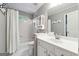 Clean bathroom with white tiles, vanity with mirror, and shower with curtain at 151 Overhill Point, Alpharetta, GA 30005