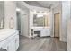 Spacious bathroom featuring double vanity, and modern fixtures, a large mirror, and two doorways at 151 Overhill Point, Alpharetta, GA 30005
