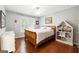 Comfortable bedroom featuring a wood sleigh bed, white dresser, and window with bright, natural light at 151 Overhill Point, Alpharetta, GA 30005