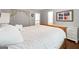Cozy bedroom with white bedding, wood furnishings, and a view to an ensuite bathroom at 151 Overhill Point, Alpharetta, GA 30005